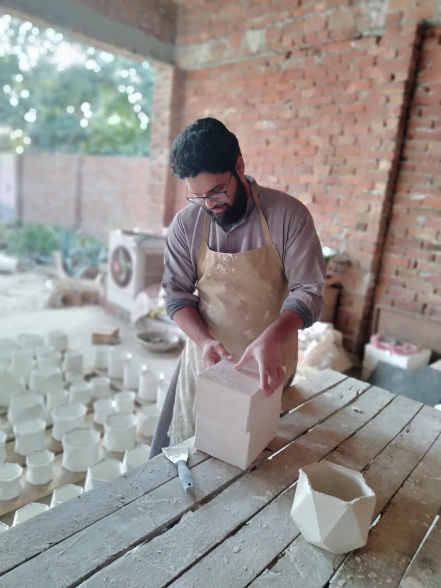 Separating the halves of a plaster mould to release a newly cast piece