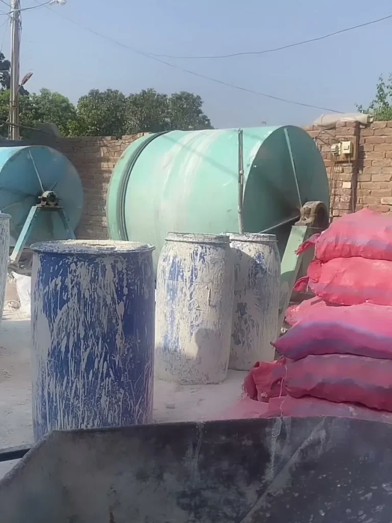 Glaze mixing drums and raw material sacks in the factory yard