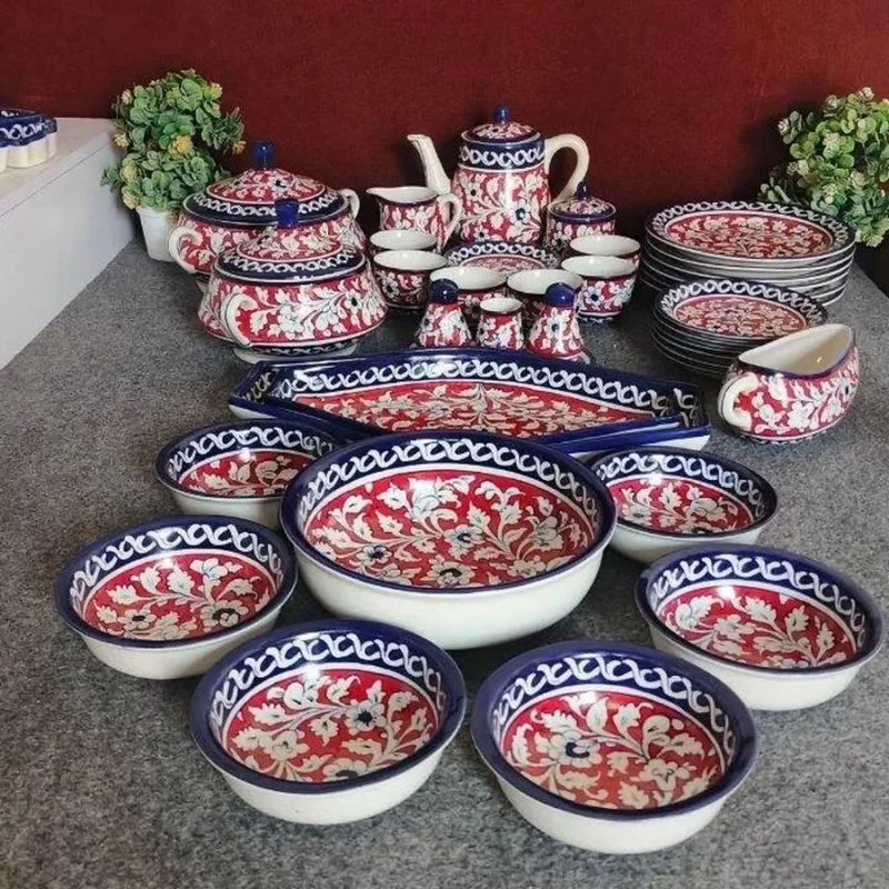 A dinner set for six in red and blue Multani pottery, with bowls, plates, a serving dish, a tea pot and a gravy boat
