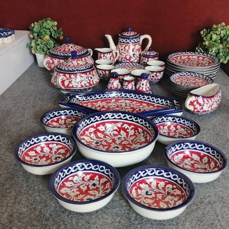 A dinner set for eight in red and blue Multani pottery, with bowls, plates, a serving dish, a tea pot and a gravy boat