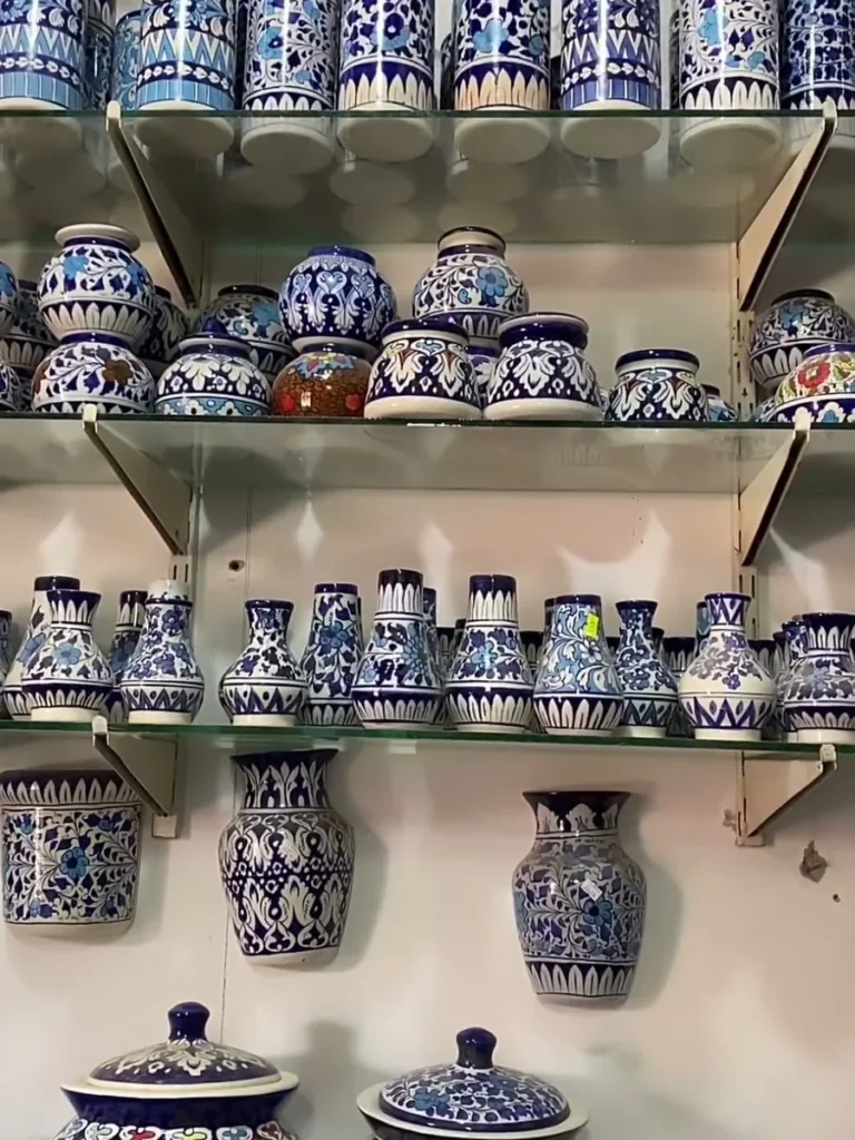 Rows of hand painted vases on the showroom shelves