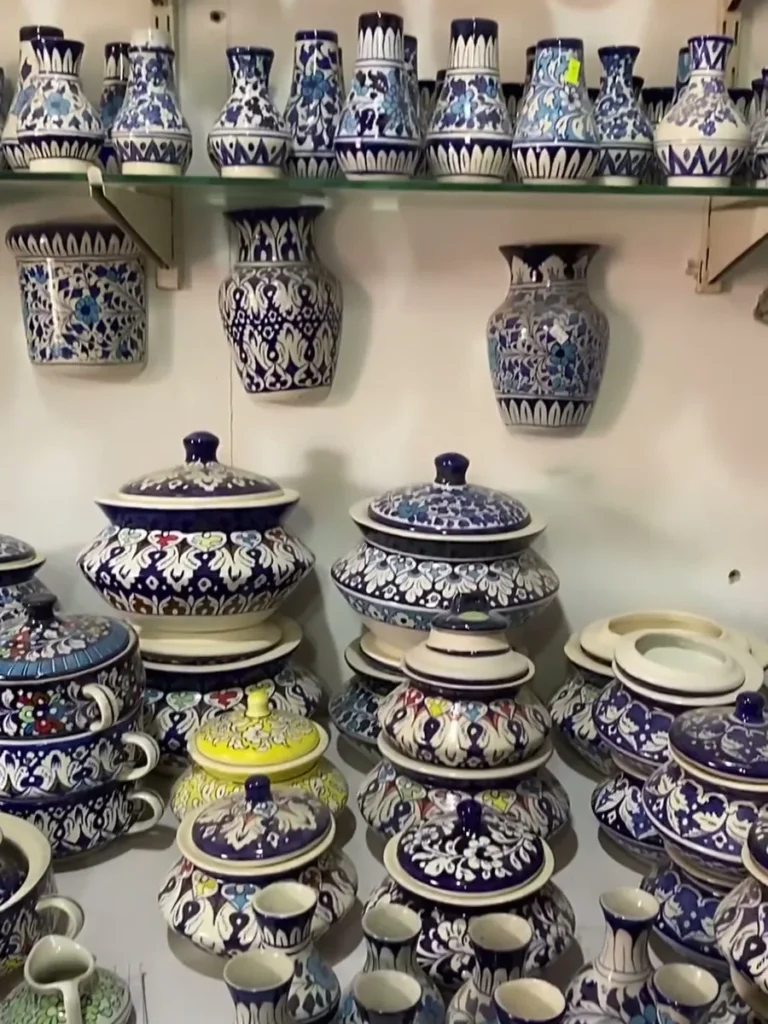 Rows of hand painted vases on the showroom shelving